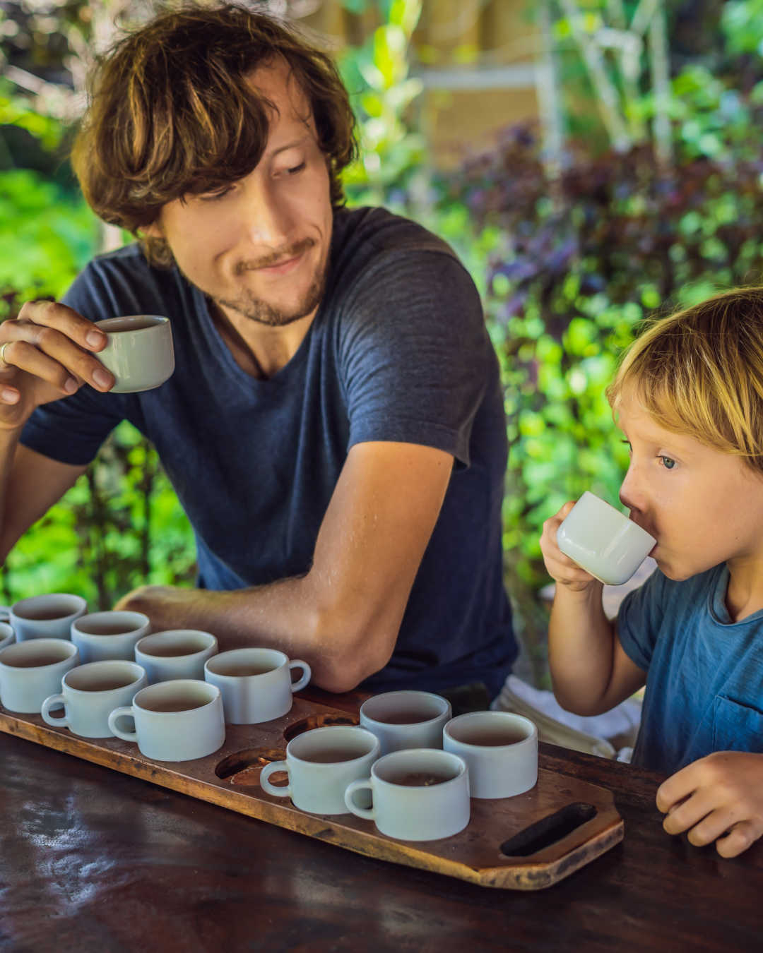 man and boy tasting coffee