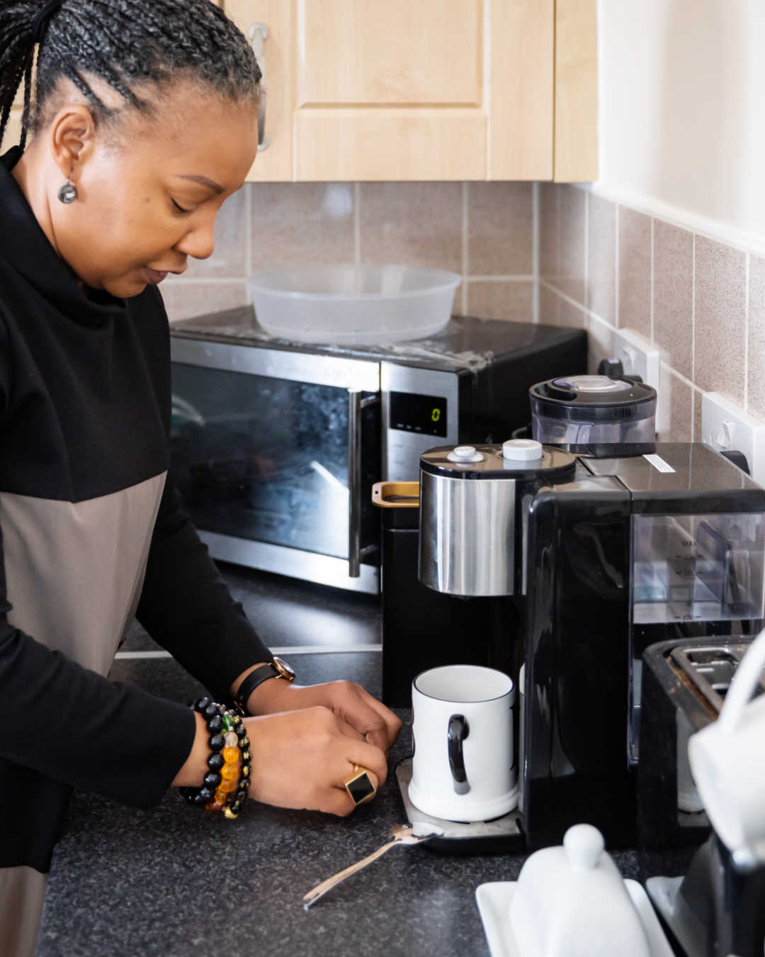 woman in kitchen making coffee