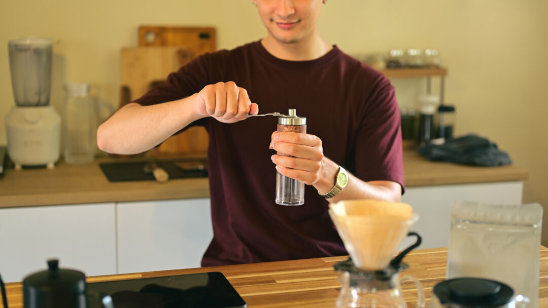 man using coffee grinder