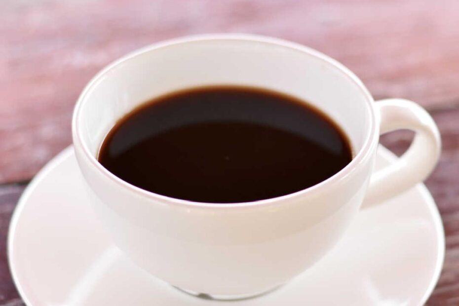 black coffee in white cup on table