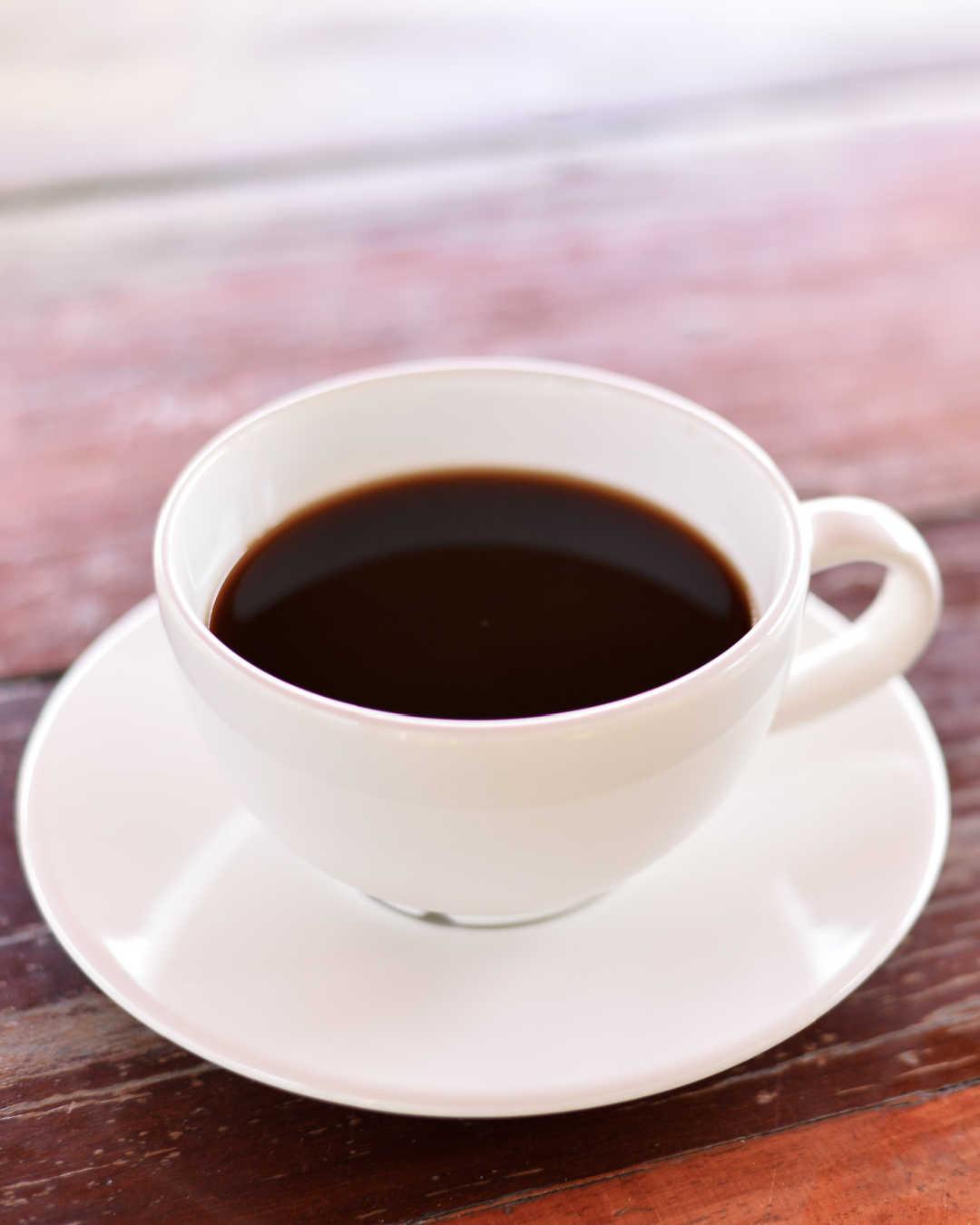 black coffee in white cup on table