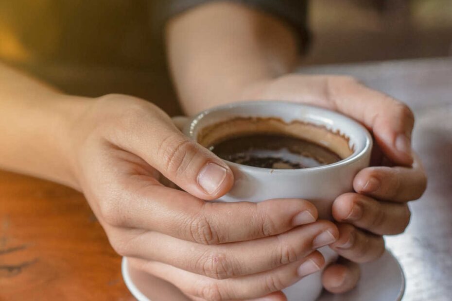 hands holding cup of coffee