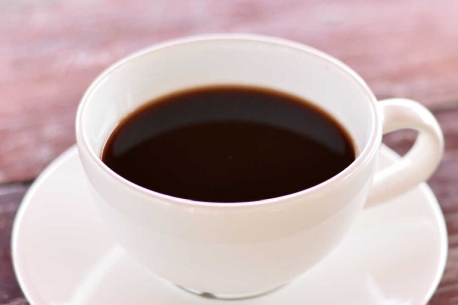cup of black coffee on simple wood table